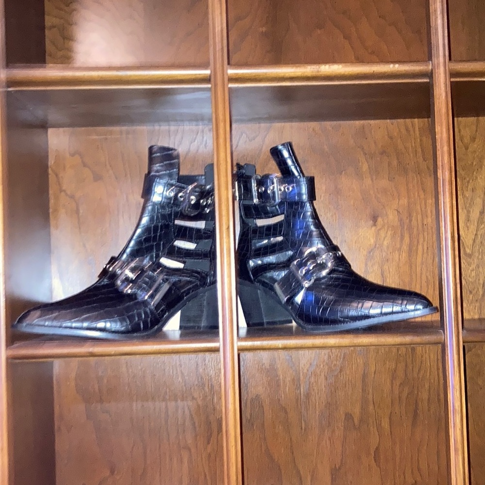Black heeled boots with zipper in back and buckles for decor. Never worn